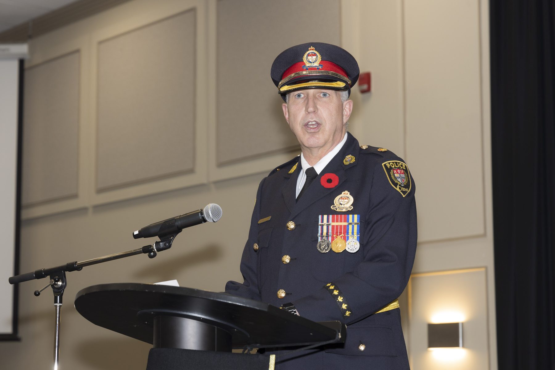 A senior Ottawa Police officer addressing a gathering from the lectern.